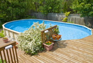 above ground pool with plants at the corner