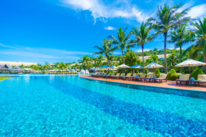 Umbrella and chair around infinity swimming pool