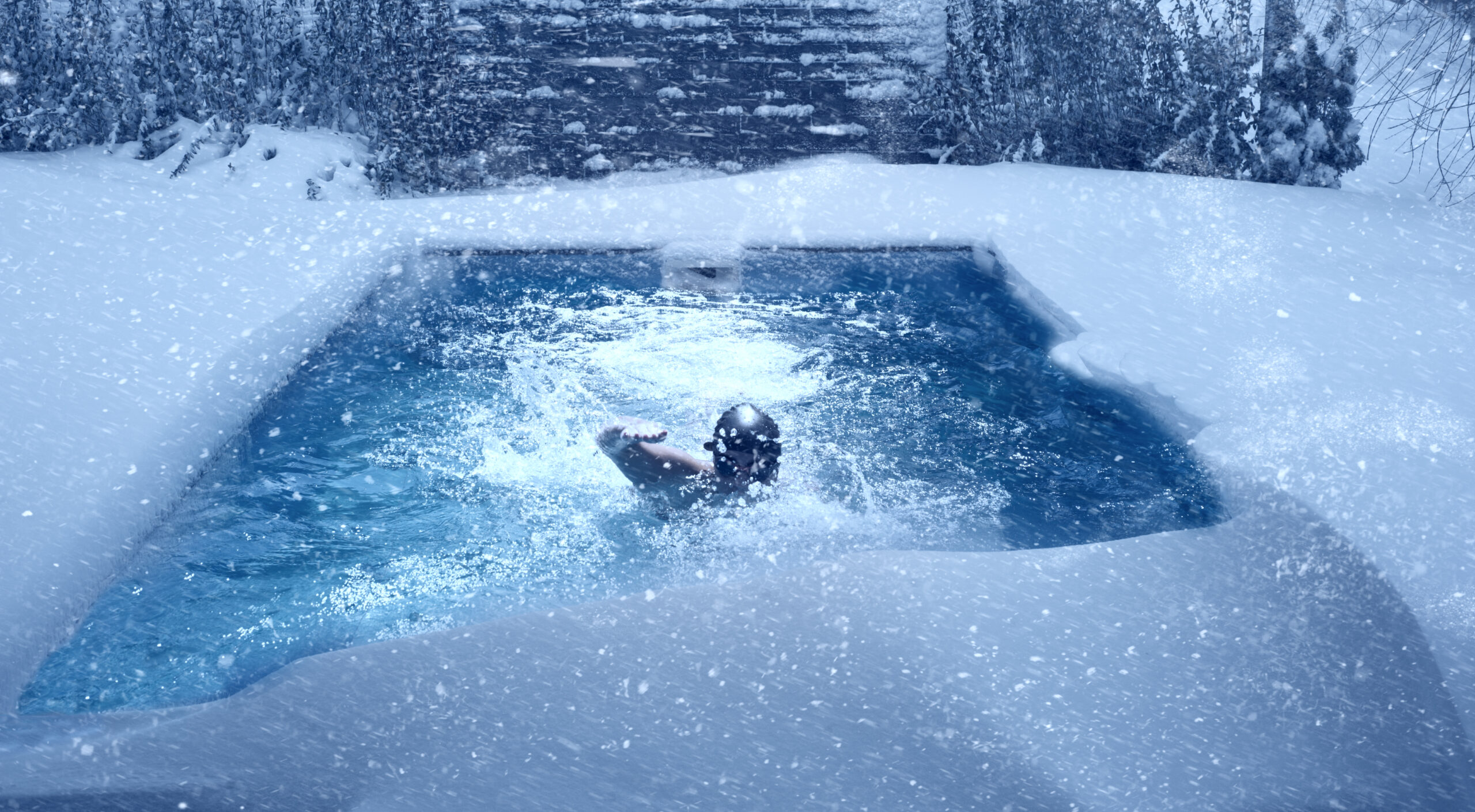 An iced swimming pool covered in a thick layer of ice and snow, revealing the winter season's harsh conditions.
