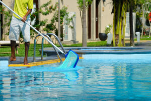 A man cleans the pool