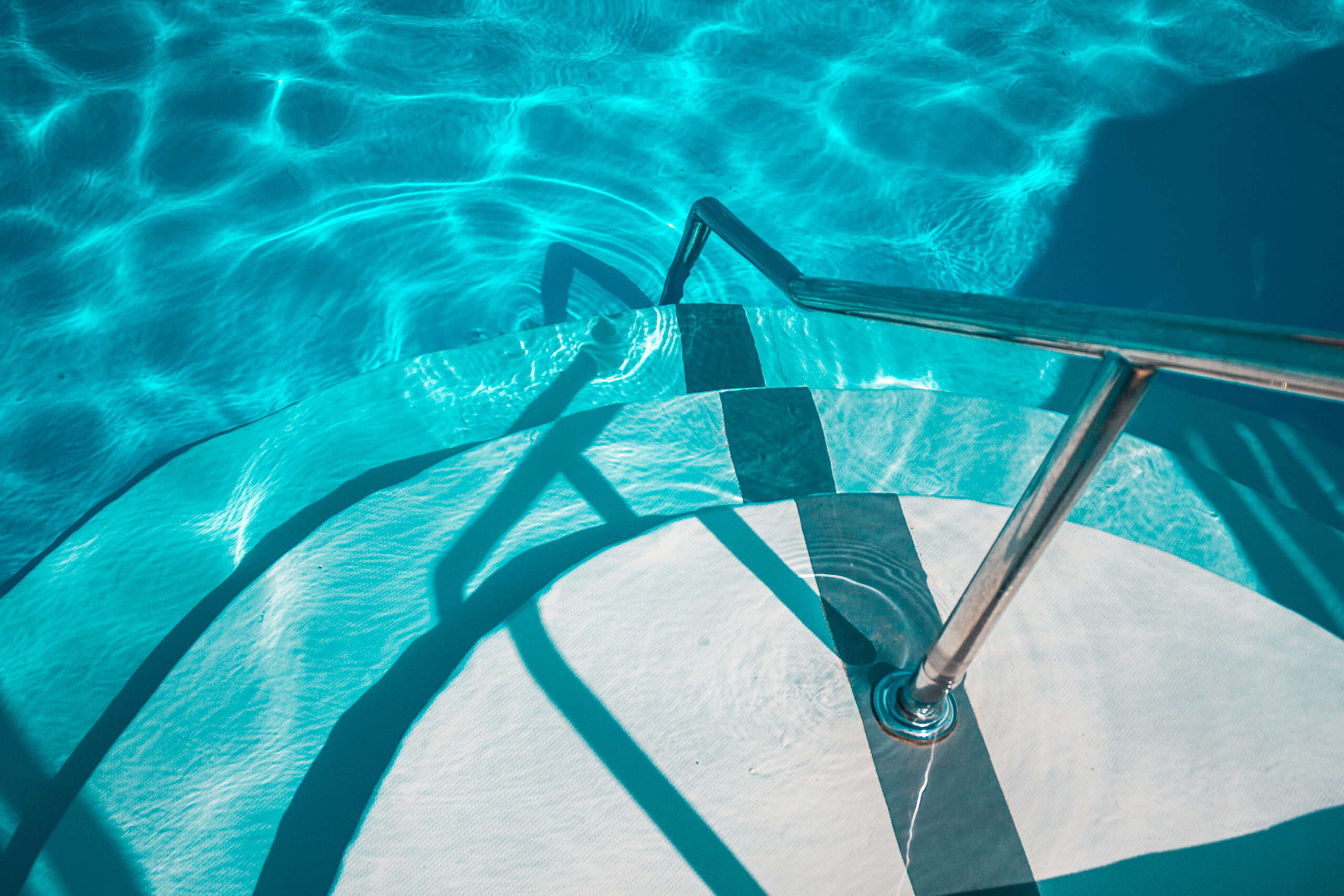 Handrails by the poolside, providing support and safety for swimmers and pool users.
