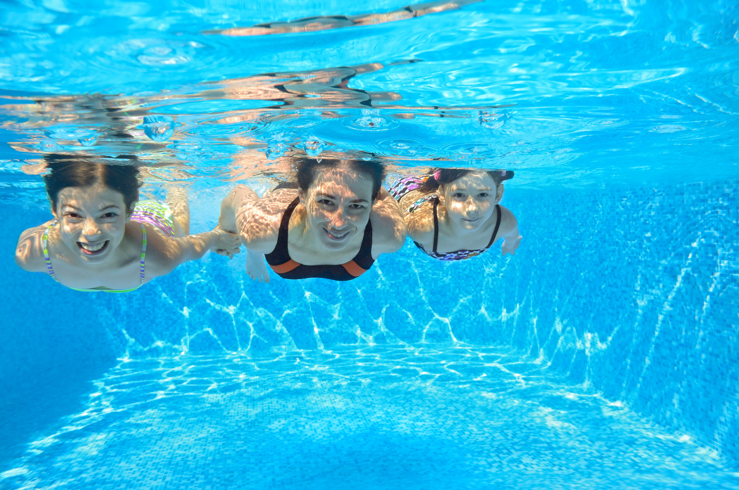 Three women having a great time swimming