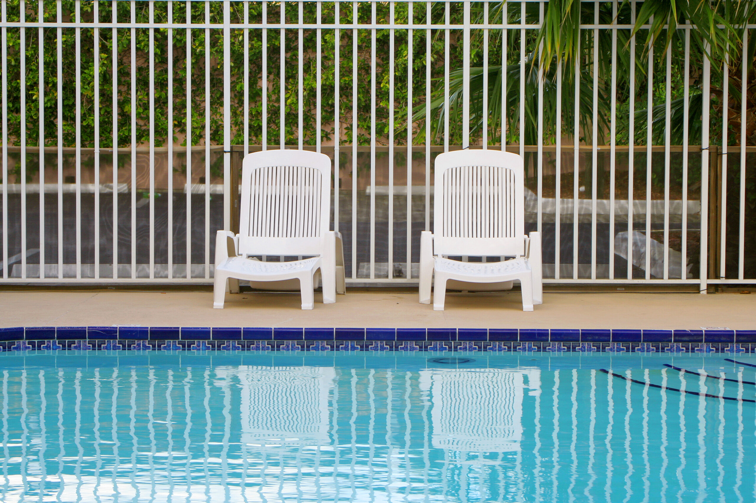 A pool area featuring a white chair