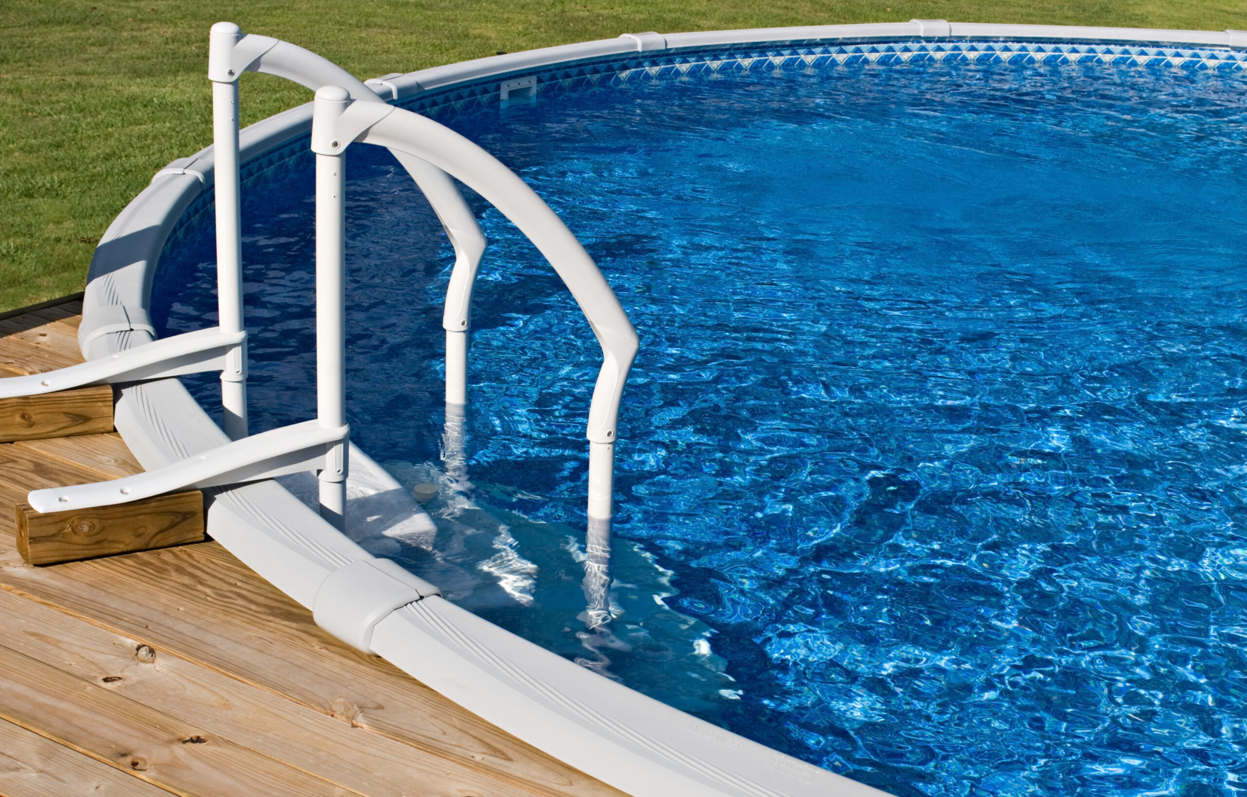 An inground pool, a permanent swimming pool structure that is installed below ground level, typically with a smooth surface and various depths for swimming.