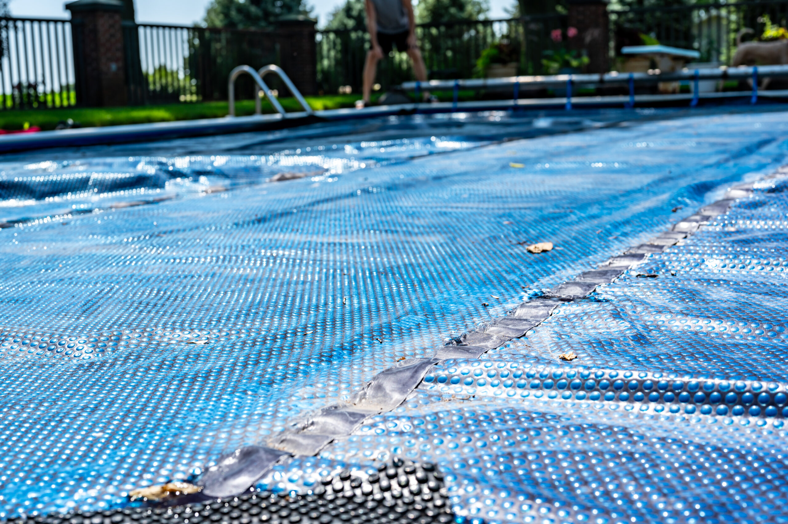 A pool cover securely placed over a swimming pool