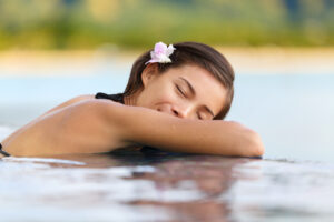 Relaxing pool woman on holidays - vacation travel