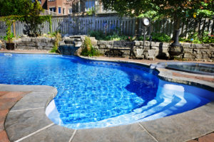 A sparkling swimming pool shimmering in the noonday sun, radiating a bright and inviting allure