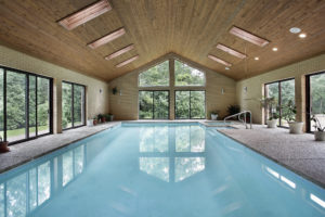 Indoor pool in luxury home with skylights