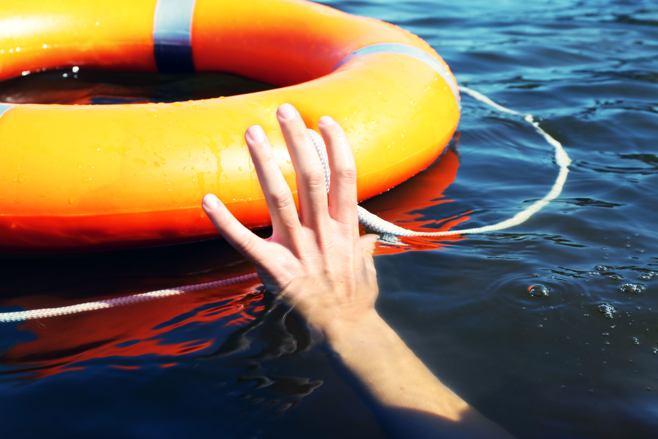 A pool float with a hand reaching out to grab it