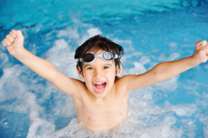 Activities on the pool, children swimming and playing in water,